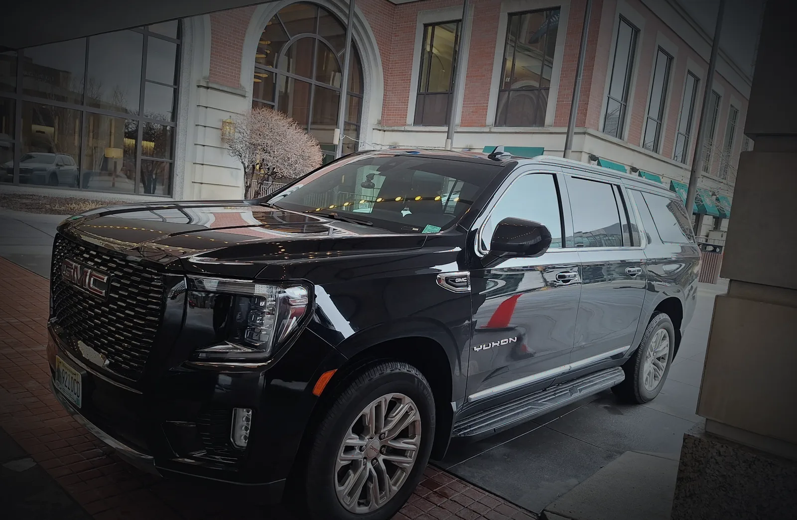 Black GMC Yukon Denali at a historic hotel entrance in Saint Paul